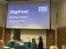 Image of the front of the auditorium at DigiFest22. The slide says 'closing remarks'.