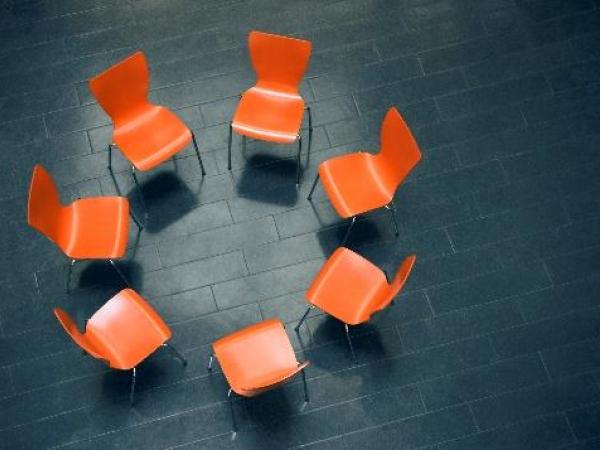Circle of chairs in group therapy setting